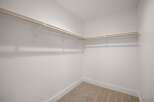 Discover ample storage in this spacious walk-in closet, featuring a double-rod system for organized hanging space.