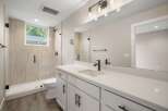 This modern bathroom features a spacious walk-in shower with elegant tilework and a sleek glass enclosure.