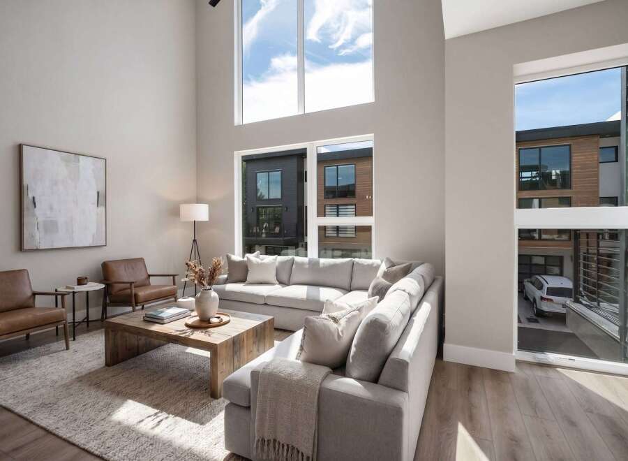 Experience modern living in this stunning home featuring a spacious, open-concept living area with soaring ceilings and abundant natural light.