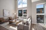 Experience modern living in this stunning home featuring a spacious, open-concept living area with soaring ceilings and abundant natural light.