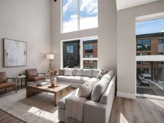 Experience modern living in this stunning home featuring a spacious, open-concept living area with soaring ceilings and abundant natural light.