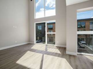 Experience modern living in this spacious, light-filled home featuring soaring ceilings and expansive windows that offer stunning views of the contemporary exterior.