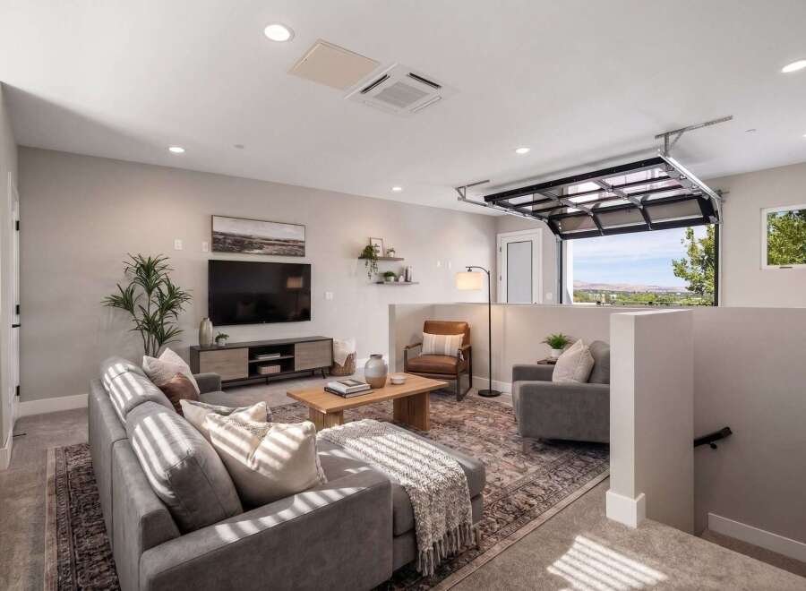 Experience modern living in this stylish living room featuring a comfortable sectional sofa, a sleek entertainment center, and a warm wooden coffee table.