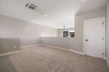 Discover this spacious loft area, perfect for a home office or additional living space.