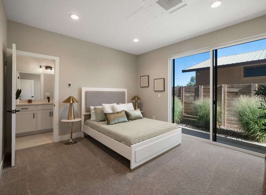 Experience modern comfort in this serene bedroom featuring a plush king-sized bed with a stylish upholstered headboard.