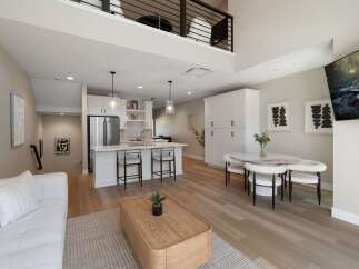 Experience modern living in this stunning loft-style apartment, featuring a sleek open-concept kitchen with stainless steel appliances and a spacious island perfect for entertaining.