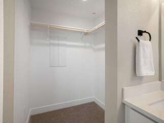 Step into this spacious walk-in closet, ready for your personal touch.