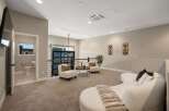 Discover this modern loft space featuring a stylish living area with plush seating and a unique curved sofa, perfect for relaxation.