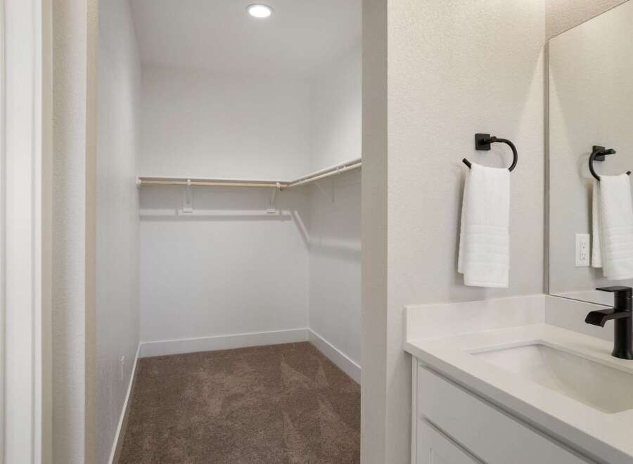 Discover ample storage in this spacious walk-in closet, perfect for organizing your wardrobe.