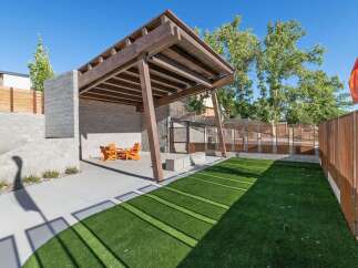 Discover this modern outdoor living space featuring a covered wooden pergola and a built-in seating area, perfect for entertaining.