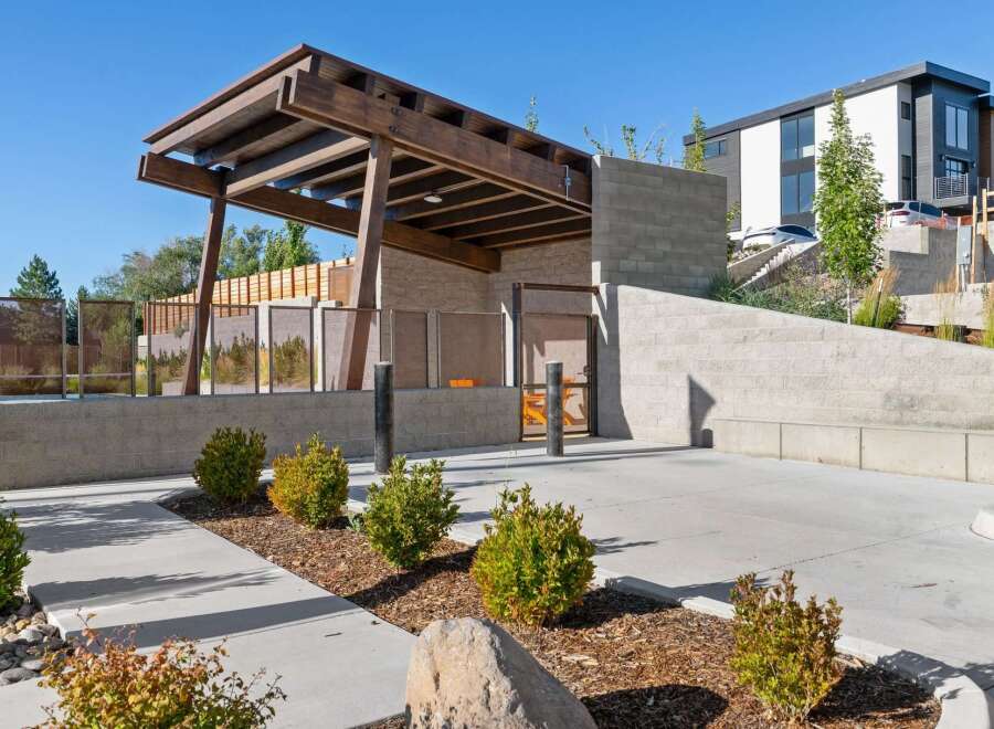 Discover modern living with this stunning property featuring a covered outdoor entertainment area with a sleek wooden pergola.