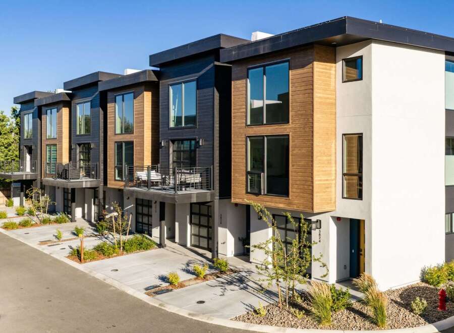 Discover modern living in these stunning townhomes featuring a striking contemporary design with wood and dark paneling accents.
