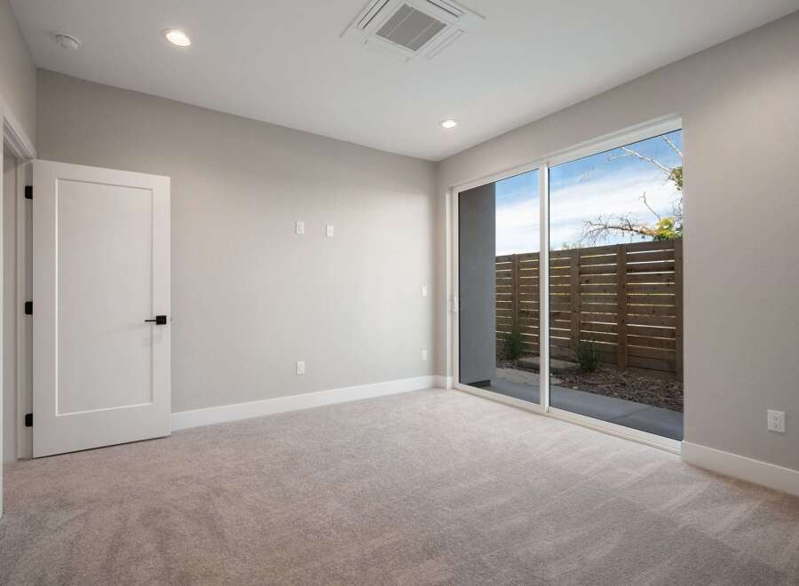 Step into this beautifully appointed room featuring plush carpeting and a modern, open-concept design.