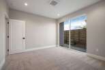 Step into this beautifully appointed room featuring plush carpeting and a modern, open-concept design.
