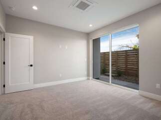 Step into this beautifully appointed room featuring plush carpeting and a modern, open-concept design.