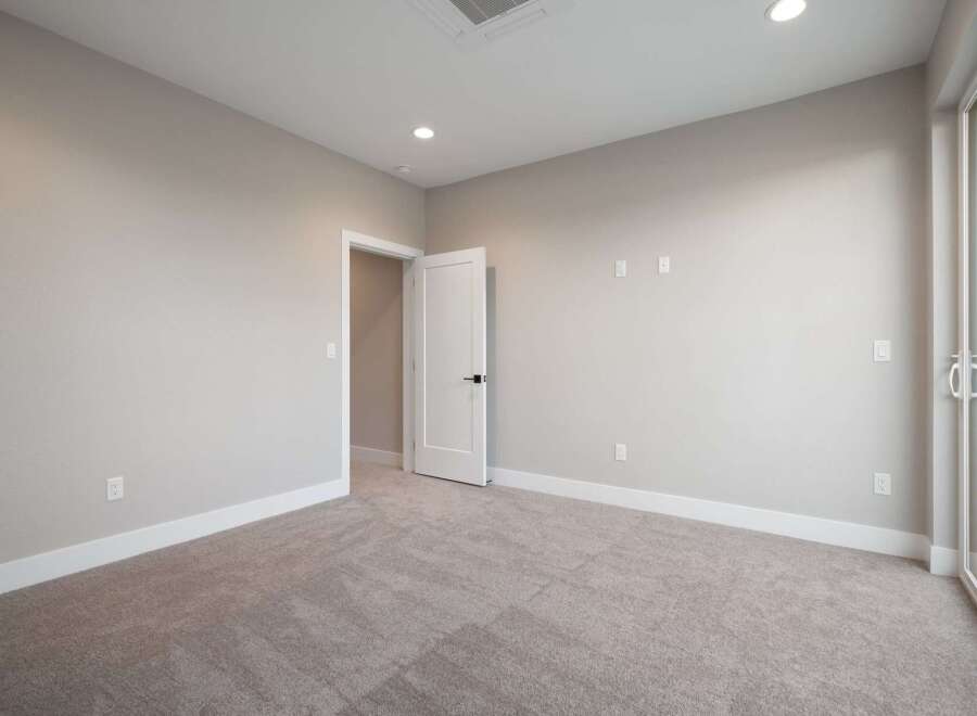Step into this beautifully appointed room featuring plush carpeting and neutral-toned walls, creating a serene and inviting atmosphere.