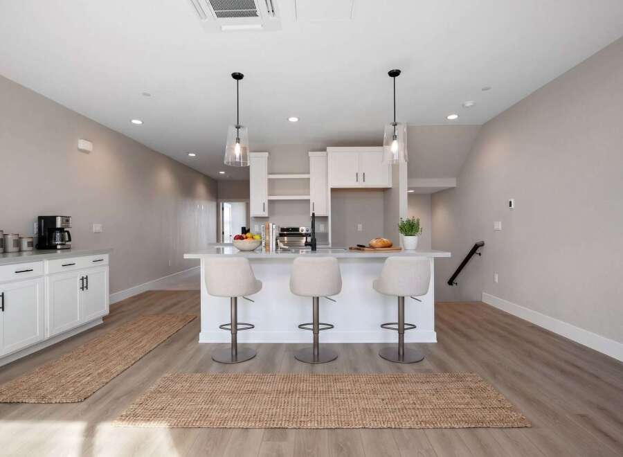 Discover modern living in this bright and airy kitchen, featuring a sleek island with bar seating perfect for casual dining or entertaining.