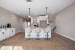 Discover modern living in this bright and airy kitchen, featuring a sleek island with bar seating perfect for casual dining or entertaining.