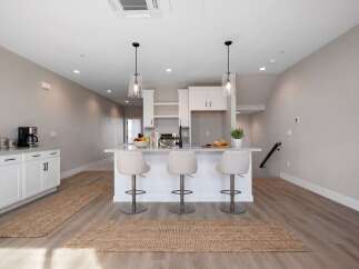 Discover modern living in this bright and airy kitchen, featuring a sleek island with bar seating perfect for casual dining or entertaining.