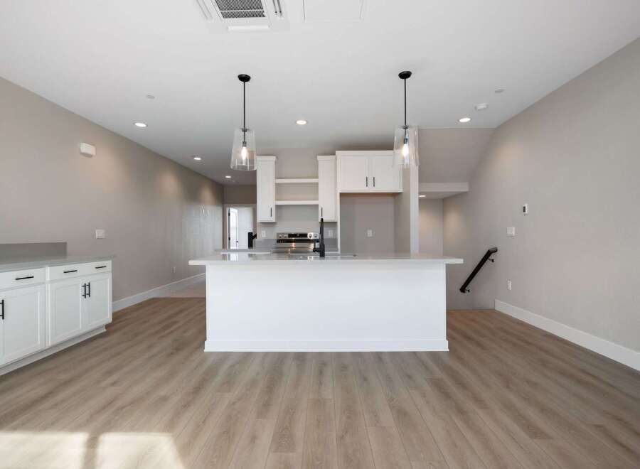 Discover modern living in this bright and airy kitchen, featuring a sleek island with bar seating perfect for casual dining or entertaining.
