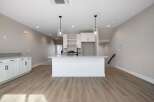 Discover modern living in this bright and airy kitchen, featuring a sleek island with bar seating perfect for casual dining or entertaining.