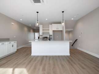 Discover modern living in this bright and airy kitchen, featuring a sleek island with bar seating perfect for casual dining or entertaining.
