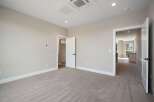 Step into this inviting bedroom, featuring plush carpeting and neutral-toned walls for a serene atmosphere.