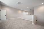 Discover this spacious loft area, perfect for a home office or secondary living space.