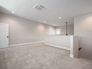 Discover this spacious loft area, perfect for a home office or secondary living space.