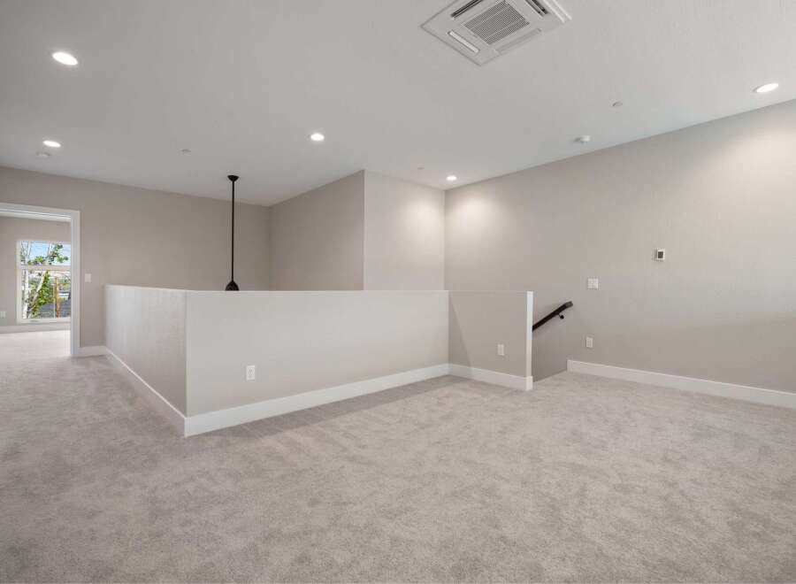 Discover this spacious loft area, perfect for a home office or secondary living space.