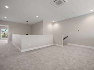 Discover this spacious loft area, perfect for a home office or secondary living space.