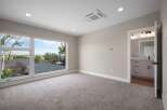 Experience breathtaking views from this spacious bedroom, featuring a large picture window that floods the room with natural light.