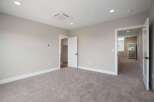 Step into this spacious bedroom featuring plush carpeting and neutral-toned walls, creating a serene atmosphere.