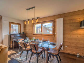 Experience cozy mountain living in this charming dining area, featuring a glass-top dining table with stylish leather chairs, perfect for intimate gatherings.
