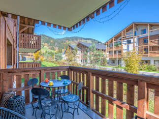 Enjoy your morning coffee or evening drink on this charming balcony, complete with a bistro set and scenic mountain views.