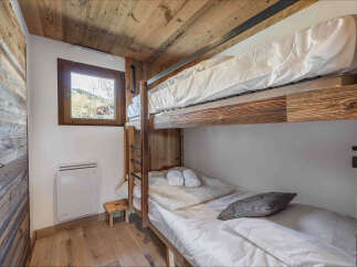 This charming bedroom features a space-saving bunk bed setup, perfect for families or guests.