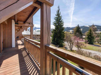 Experience breathtaking mountain views from this charming wooden balcony, perfect for enjoying your morning coffee or evening relaxation.