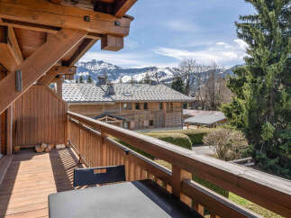 Experience breathtaking mountain views from this charming wooden balcony, perfect for enjoying your morning coffee or evening relaxation.