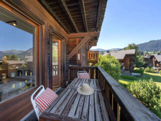 Enjoy breathtaking mountain views from this charming wooden balcony, perfect for your morning coffee or evening relaxation.