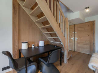 Discover this charming space featuring a cozy wooden staircase leading to the upper level.