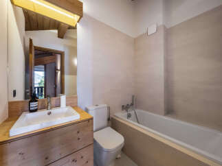 Experience modern comfort in this beautifully appointed bathroom, featuring a sleek white bathtub and a stylish vanity with a vessel sink.