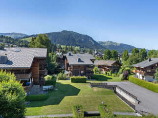 Experience alpine living in this charming wooden chalet, nestled amidst lush greenery and offering breathtaking mountain views.