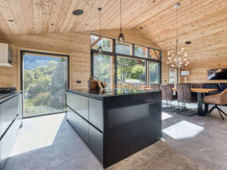 Experience modern mountain living in this stunning open-concept kitchen and dining area.