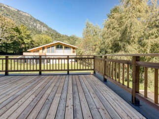Enjoy breathtaking mountain views from this expansive wooden deck, perfect for outdoor entertaining or quiet relaxation.