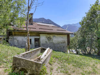 Discover this charming rustic property nestled in a serene mountain landscape.