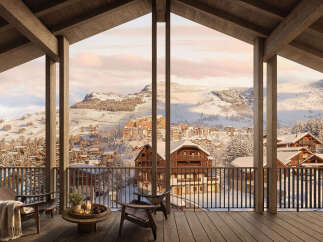 Experience breathtaking mountain views from this stunning chalet, featuring a spacious balcony perfect for enjoying the winter wonderland.
