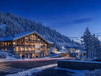 Experience luxurious mountain living in this stunning chalet-style property nestled amidst snow-covered pines.