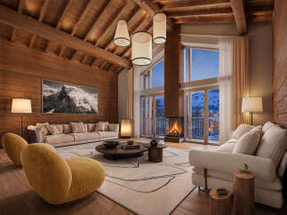 Experience luxurious mountain living in this stunning chalet, featuring a grand living area with a soaring wood-beamed ceiling and a magnificent stone fireplace.