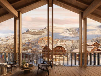 Experience breathtaking mountain views from this stunning chalet, featuring a spacious balcony perfect for enjoying the winter wonderland.