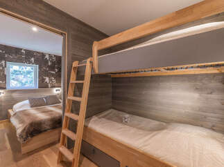 This charming bedroom features a cozy bunk bed setup, perfect for families or accommodating guests.